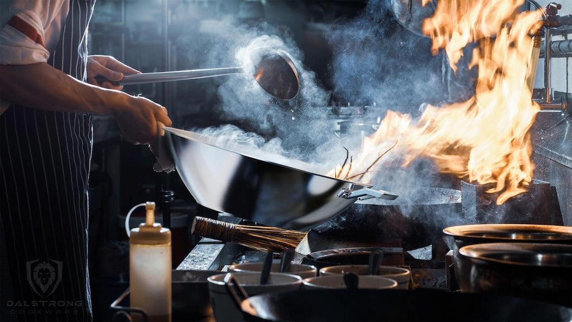 Chef cooking with a wok over an open flame in a commercial kitchen